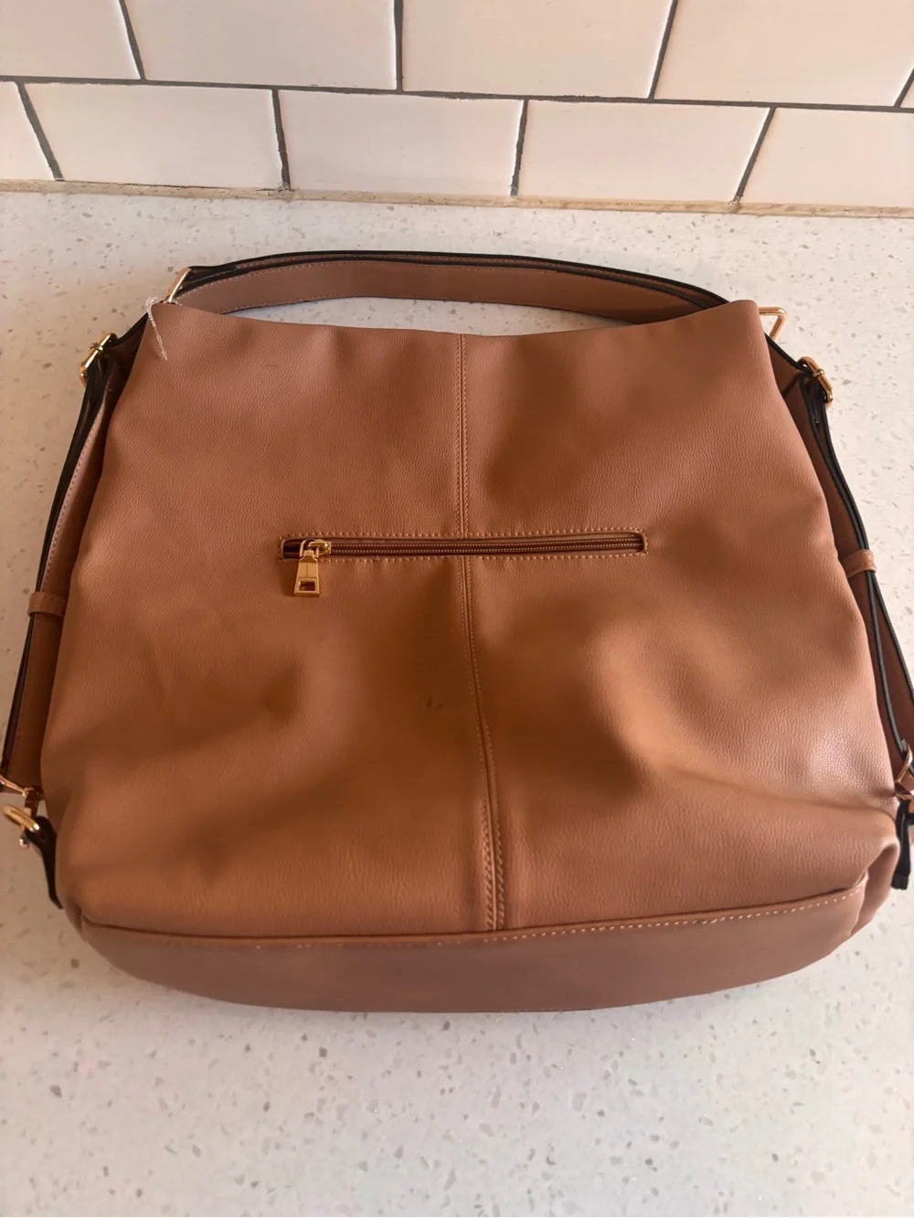 Tan Leatherette Shoulder Bag with Front Zip Pockets. Hand strap or backpack